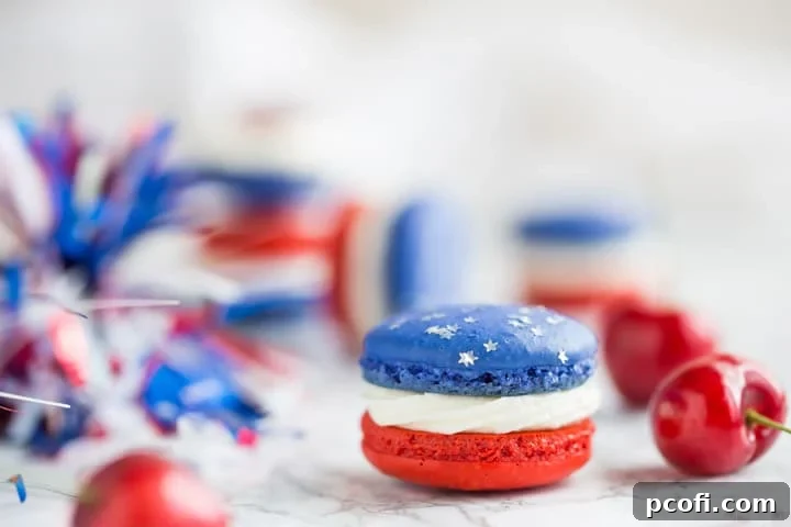 Assortment of Red, White, and Blue Cherry Cheesecake Macarons with edible star glitter, ready for a patriotic holiday spread.