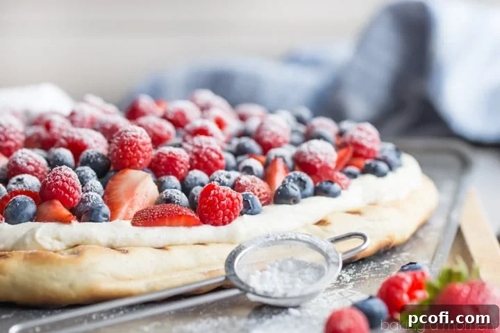 A single slice of grilled berry pizza with whipped ricotta and fresh berries, perfectly cut and ready to be enjoyed as a refreshing summer dessert.