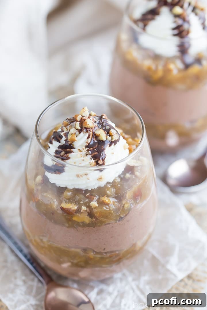 Layered German Chocolate Cheesecake Mousse with chocolate syrup and pecans