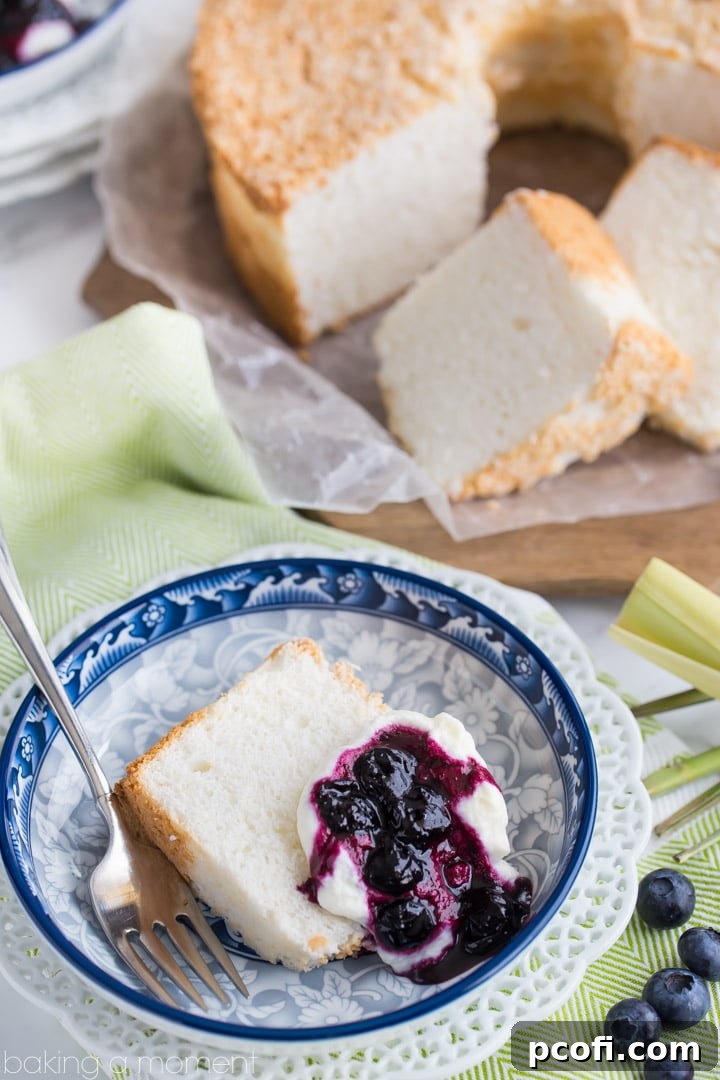 Classic Angel Food Cake: perfectly sweet & light as a cloud, served with fresh whipped cream and a citrus-y blueberry lemongrass topping.