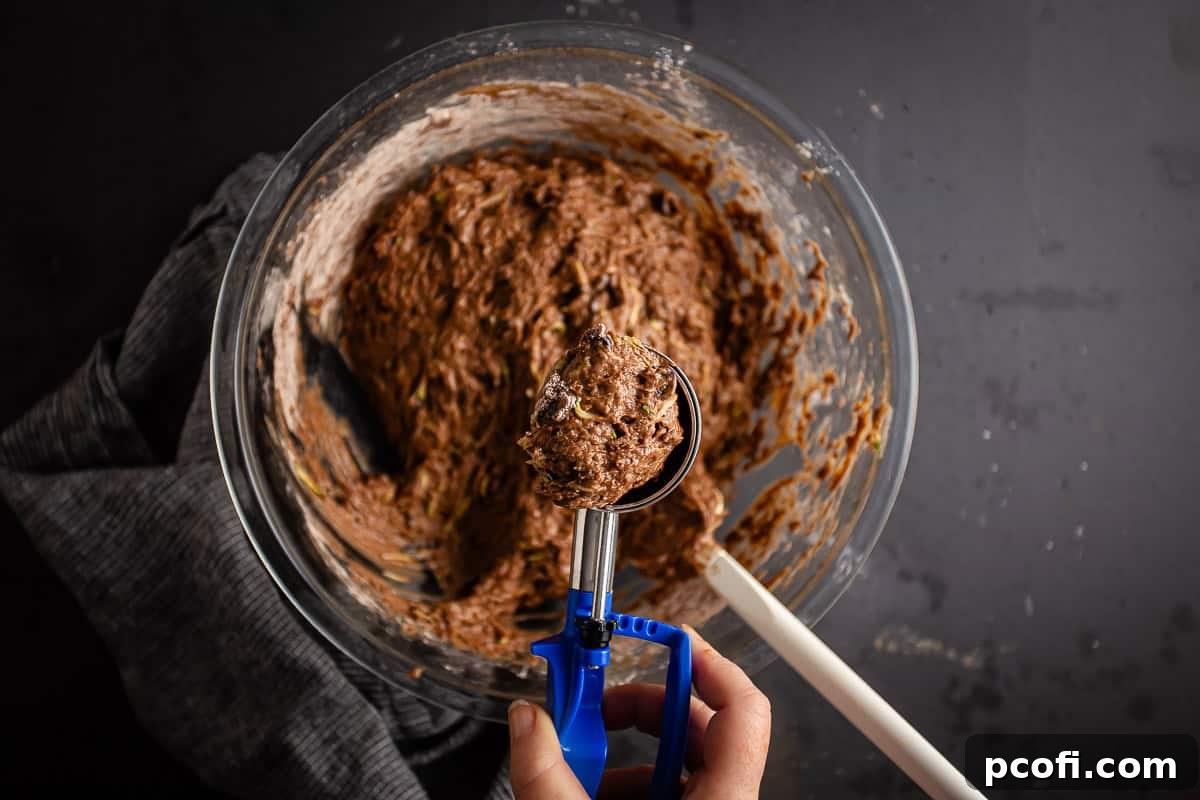 Portioning out muffin batter with a trigger scoop.