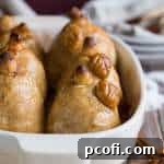 A top-down view of a single pear dumpling with golden pastry and cinnamon sauce.