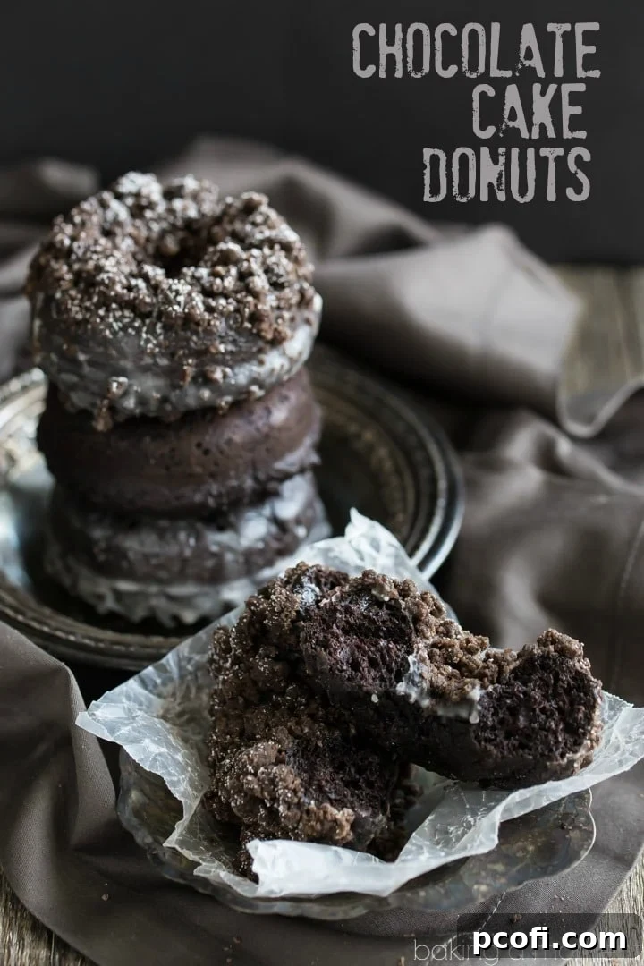 The most chocolate-y baked donuts ever! Experience moist, tender cake donuts with a rich vanilla glaze and a generous chocolate crumb topping for an unforgettable treat.