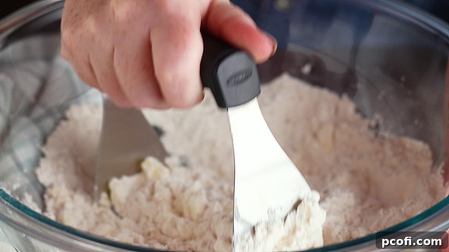 Cutting butter into dry ingredients with a pastry blender.