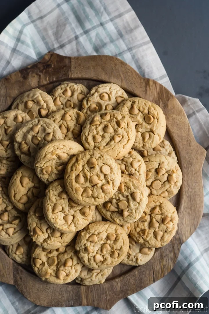 A close-up of a stack of Soft Double Peanut Butter Chip Cookies, showcasing their perfectly golden edges and irresistibly soft centers.