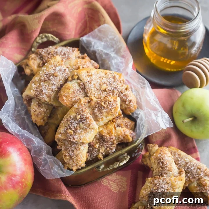 Apple Honey Rugelach: tender cream cheese pastries filled with charoset- an apple/honey/walnut mixture that's perfect for Rosh Hashana or any other fall occasion! 