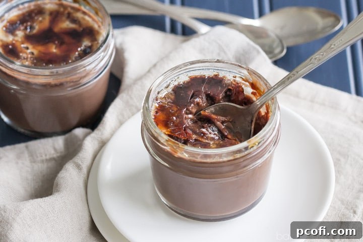 Finished chocolate creme brulee, showing the cracked caramelized sugar topping and creamy interior