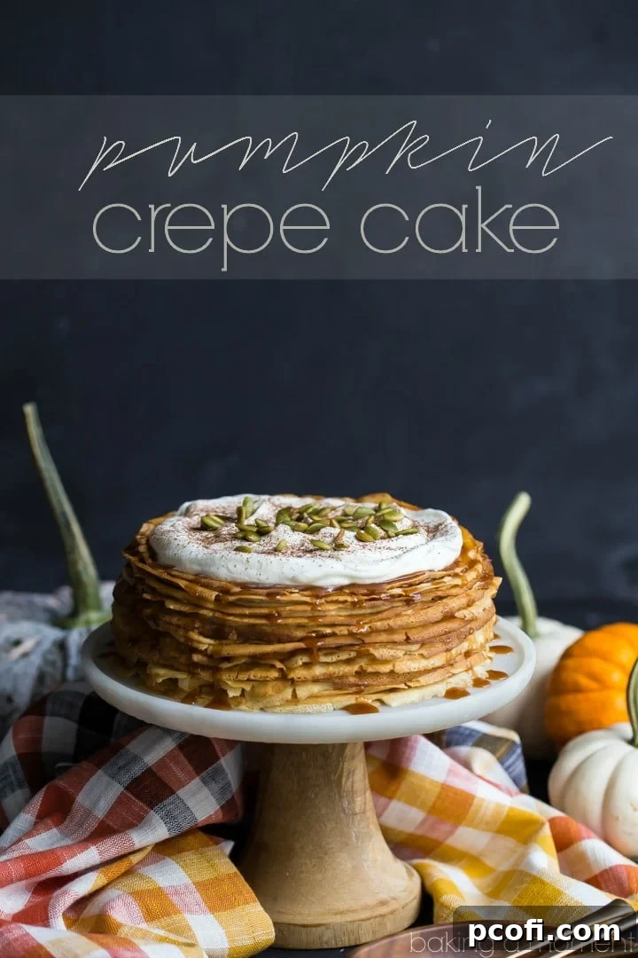 Close-up of a slice of Pumpkin Crepe Cake revealing numerous layers of thin crepes and creamy pumpkin filling, ideal for fall gatherings.