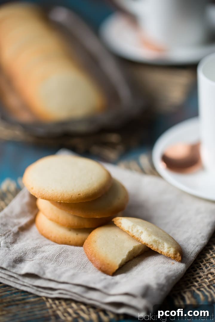 Freshly baked Brown Edge Wafers cooling on parchment paper on a baking sheet, ready to be transferred