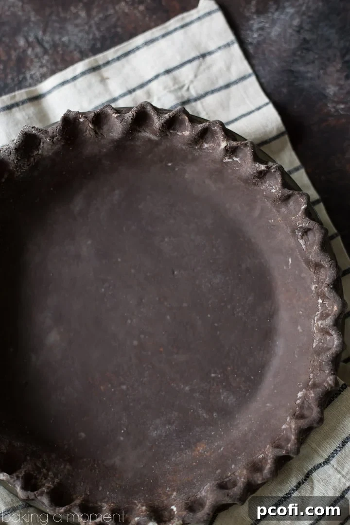 A slice of pie with a rich chocolate crust, revealing its perfectly flaky layers and inviting texture. A dessert masterpiece.