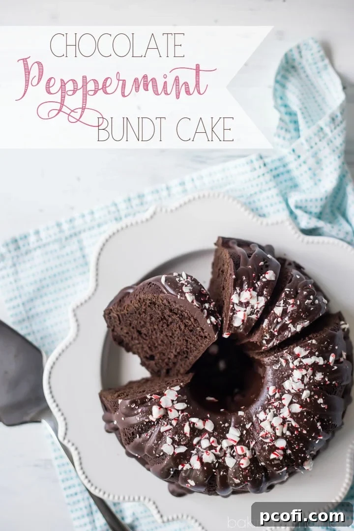 A slice of moist Chocolate Peppermint Bundt Cake revealing its rich interior, topped with glistening ganache and colorful candy cane bits, ready for serving.