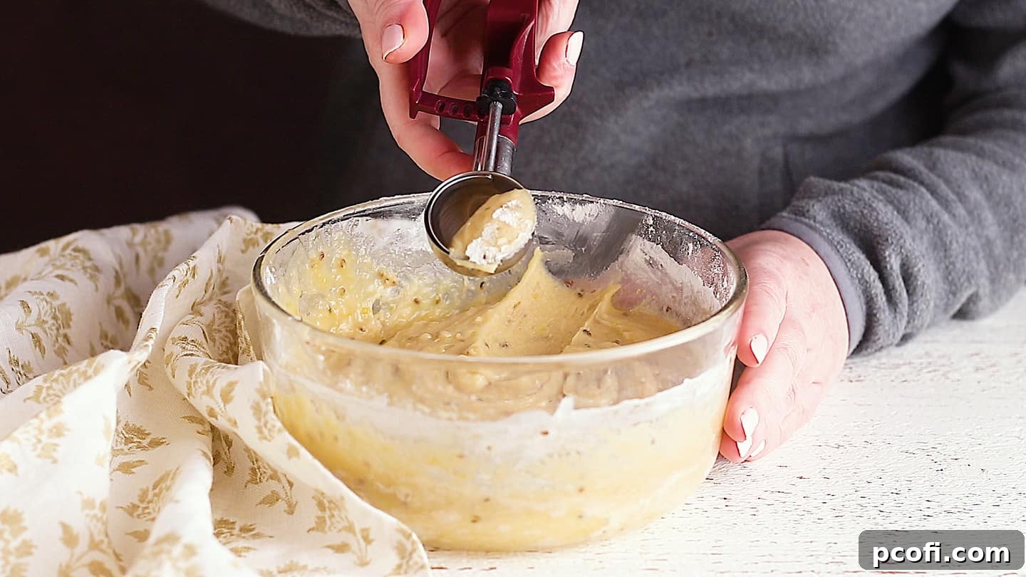 Scooping pizzelle dough with a cookie scoop.