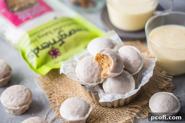 Platter of freshly baked Cinnamon Eggnog Donut Holes, with some coated in glaze, ready to be enjoyed.