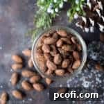 Gingerbread Spiced Almonds in a jar, ready for gifting.