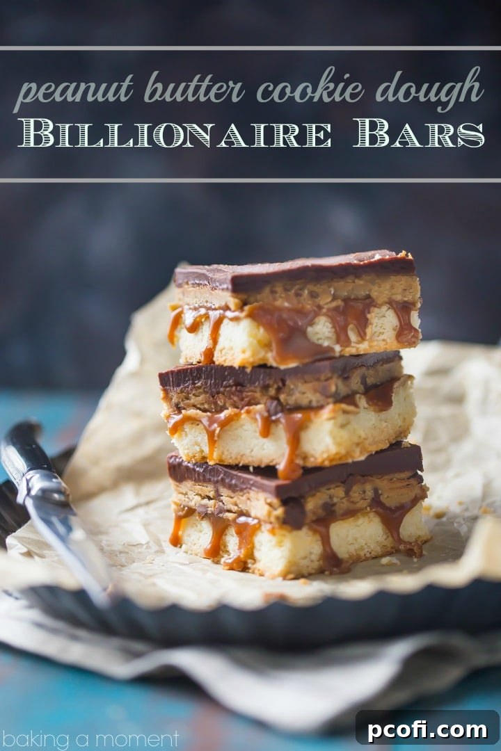 Close-up of Peanut Butter Cookie Dough Billionaire Bars showing the distinct layers of shortbread, caramel, cookie dough, and ganache.