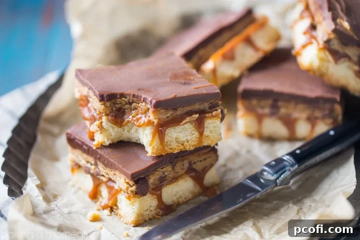 Assortment of Peanut Butter Cookie Dough Billionaire Bars arranged on a serving platter, ready to be enjoyed.