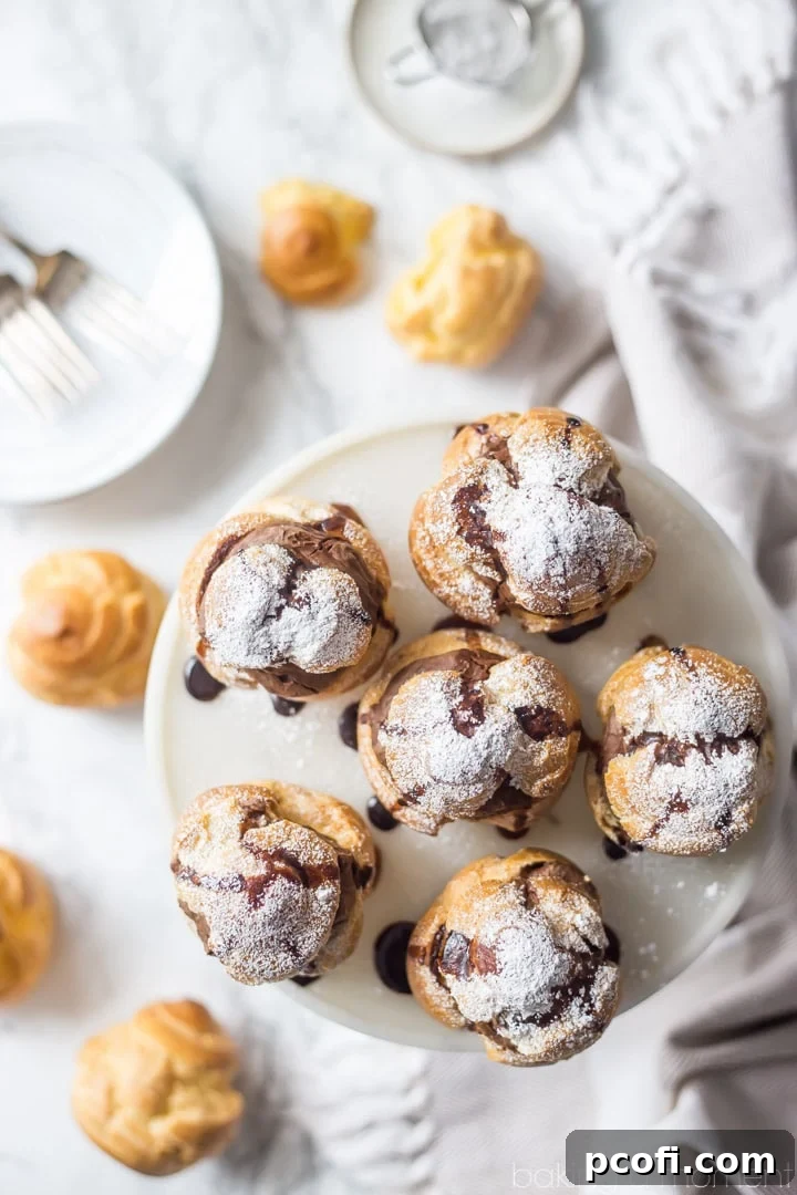 Several Mocha Cream Puffs arranged on a serving plate, highlighting their classic shape, rich color, and inviting appearance.