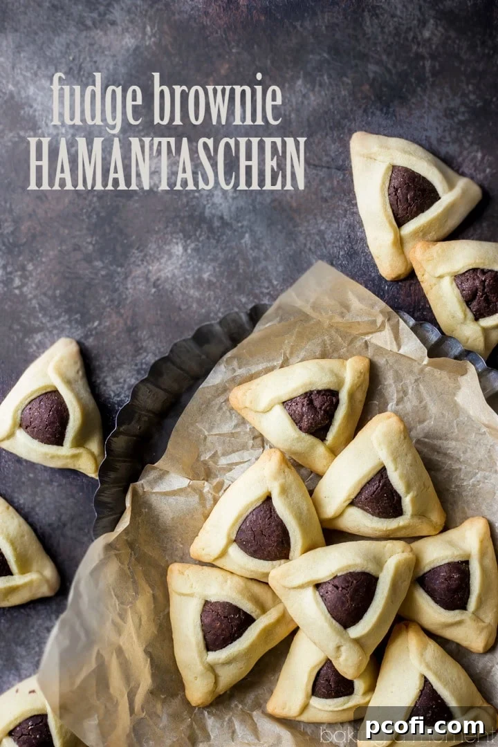 Fudge Brownie Hamantaschen - A plate of freshly baked hamantaschen, showcasing their golden sugar cookie exterior and rich brownie filling peeking from the center. A tempting dessert for any occasion.