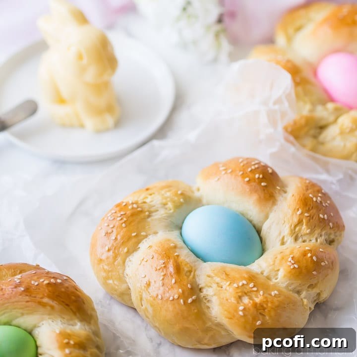 Easter Egg Bread: a golden brown braided loaf with a pastel-colored egg nestled in the middle.  