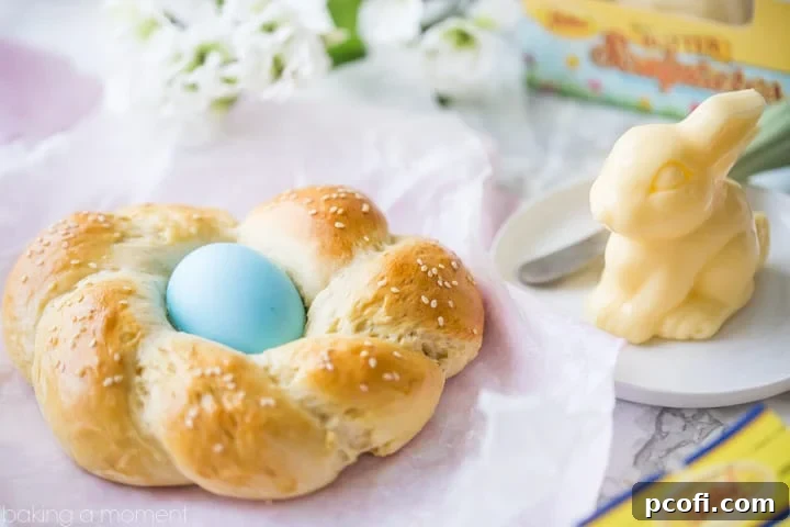 Easter Egg Bread: a golden brown braided loaf with a pastel-colored Easter egg nestled inside, and a sweet little molded butter in the shape of a bunny. 