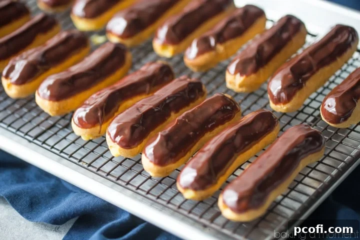 Close-up of an eclair, showing the inside filled with creamy vanilla pastry cream, a perfect cross-section.
