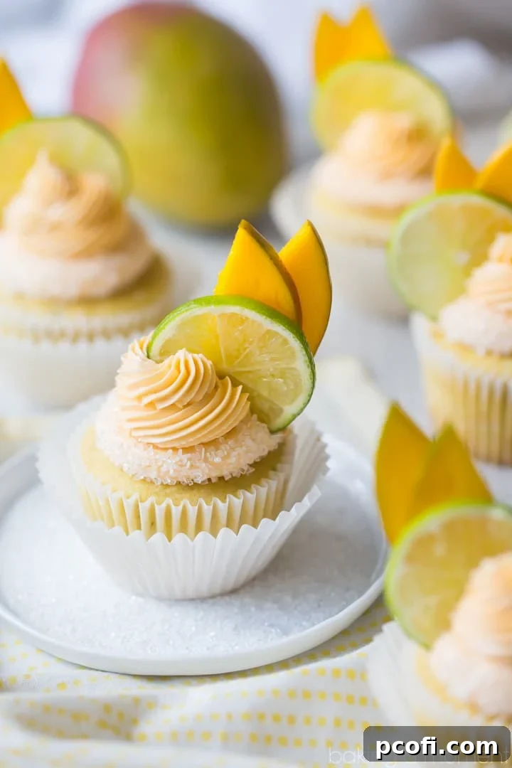 Mango Margarita Cupcakes: The flavors are exquisite, mirroring a perfect mango margarita with sweet mango, fresh lime, and a boozy hint of tequila. A delicious food dessert cupcake.