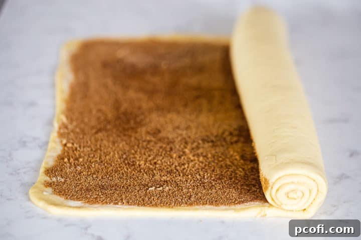 Rolling sticky buns into a log.