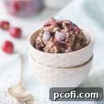 A close-up of a serving of homemade chocolate cherry chip ice cream.