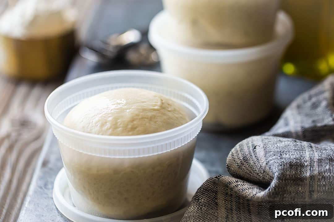 Prepared make-ahead pizza dough balls, stored in clear plastic containers for refrigeration or freezing.