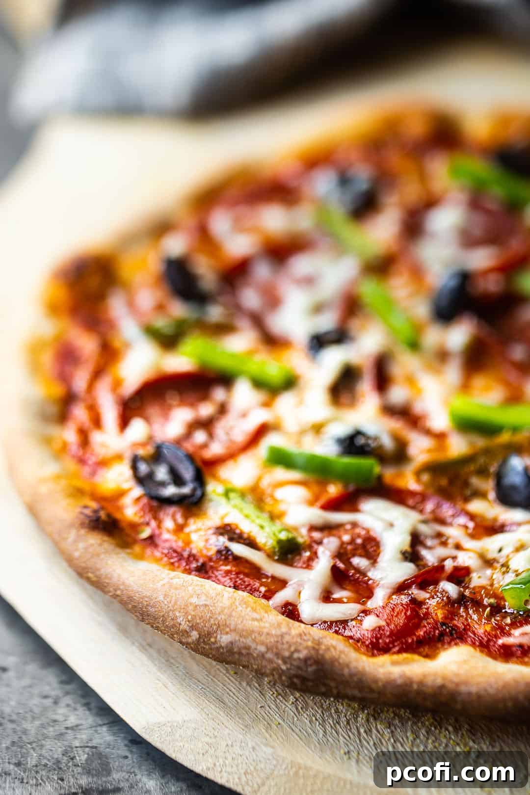 The best pizza dough recipe, ready for baking with fresh toppings, showcasing a perfectly risen and prepared crust.