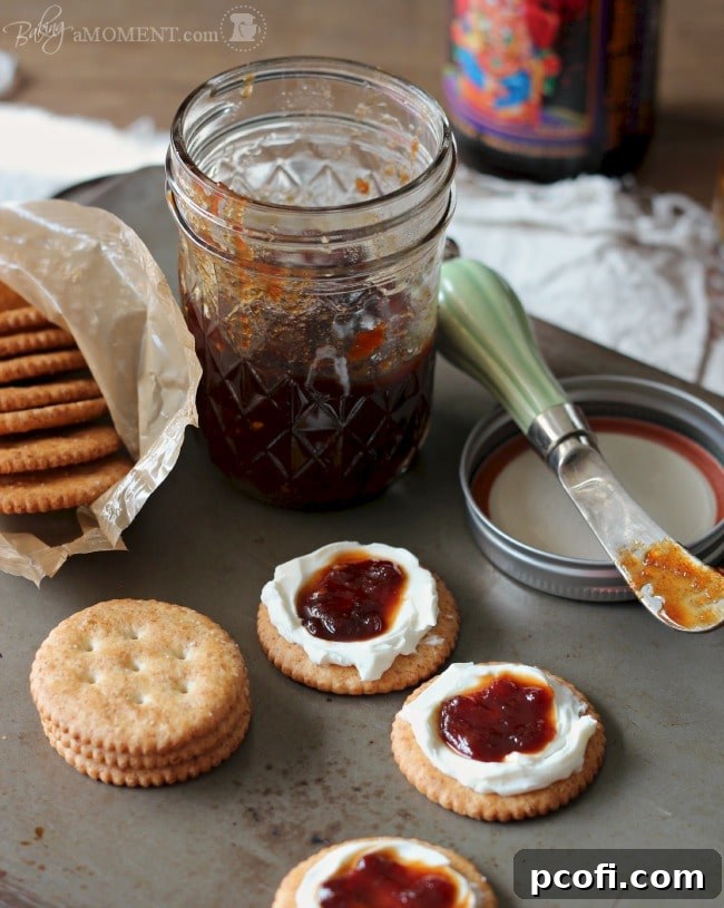 Close-up of bubbling, reducing tomato jam in a wide skillet, showing its progress