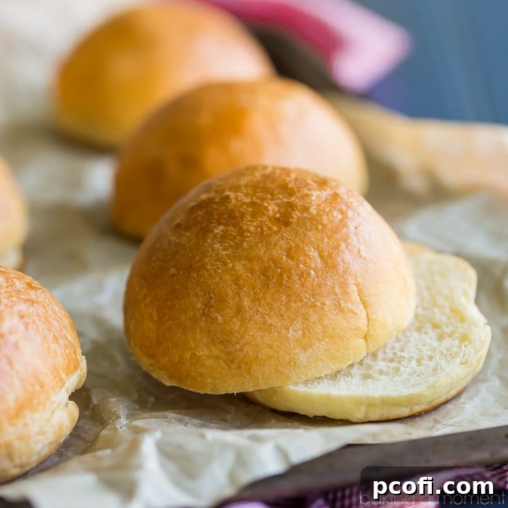 Soft, golden-brown brioche hamburger buns stacked, ready for gourmet burgers