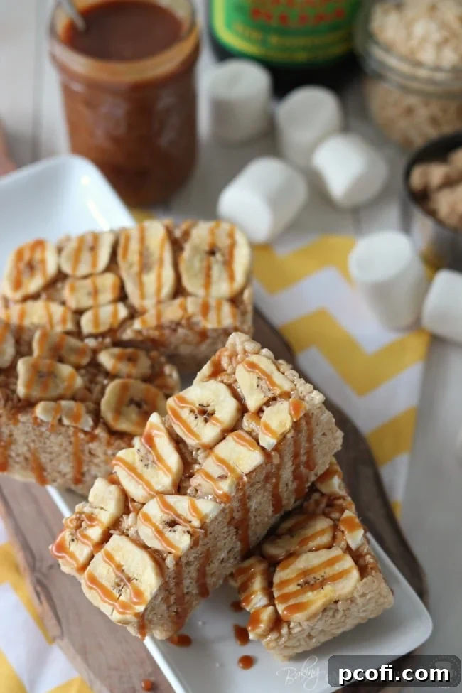 Stacked Bananas Foster Rice Krispie Treats drizzled with salted caramel
