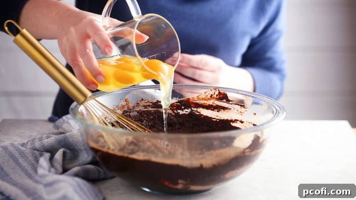 Adding eggs to homemade brownies.