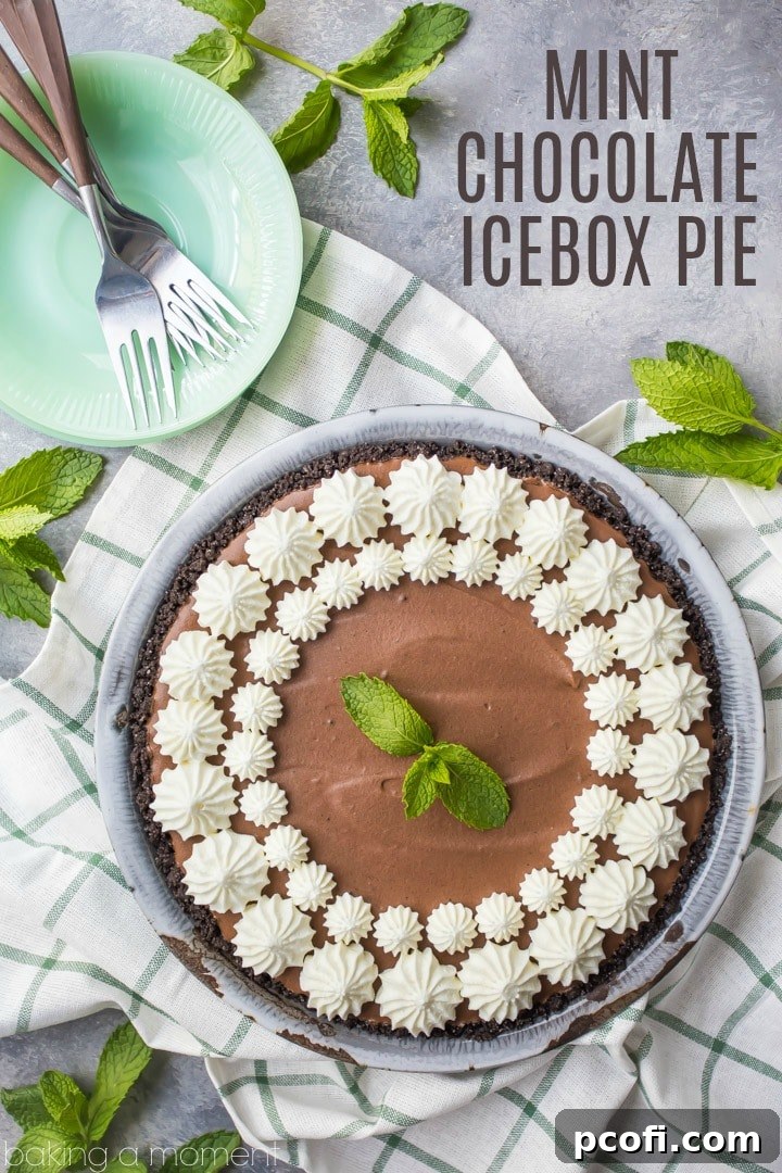 A close-up of a slice of Mint Chocolate Icebox Pie, showcasing the layers of crunchy chocolate cookie crust, light mint chocolate mousse, and a fluffy whipped cream topping. A truly irresistible summer dessert.