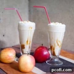 Caramel Apple Milkshakes topped with whipped cream and apple slices