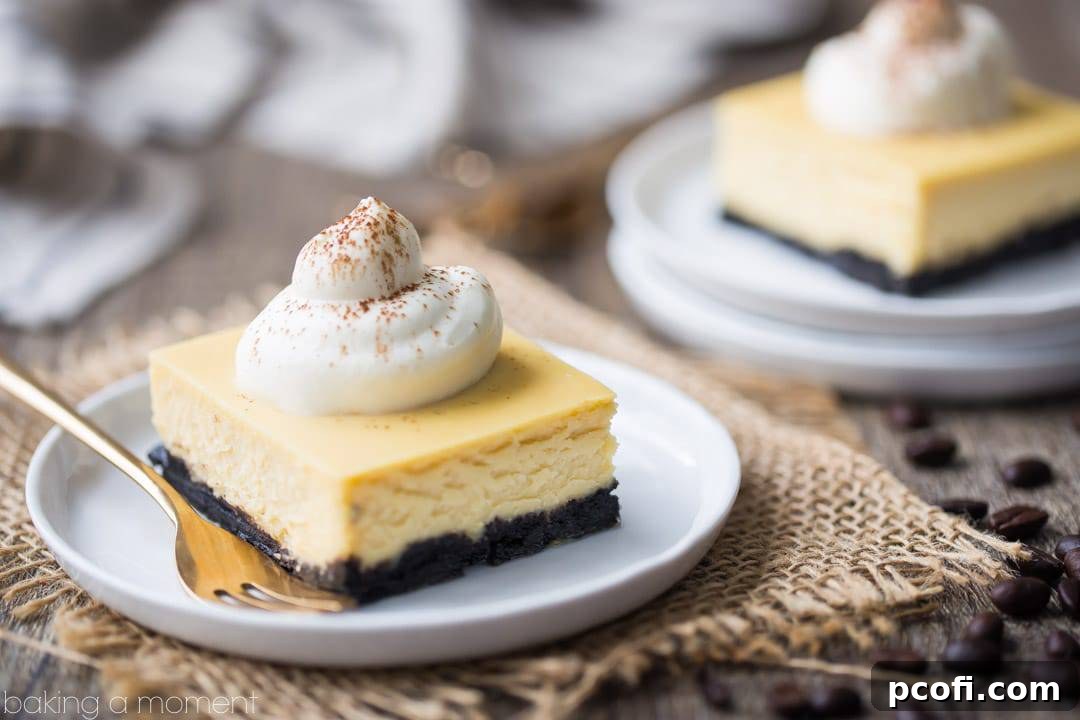 Individual White Russian Cheesecake Bars on a serving platter, garnished with whipped cream and a dusting of cocoa powder.