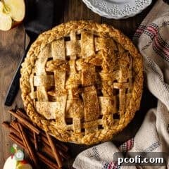 A beautifully baked apple pie with a golden lattice top, showcasing its rustic charm.