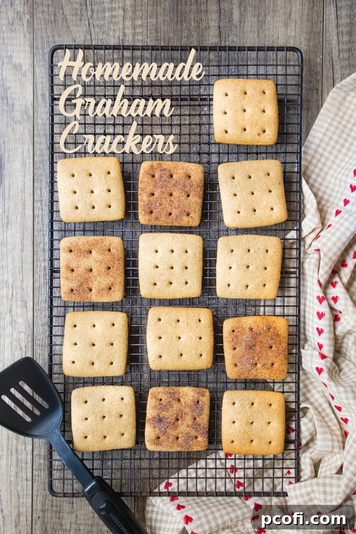 A stack of perfectly baked homemade graham crackers, with a rich, inviting golden-brown color and characteristic perforated pattern.