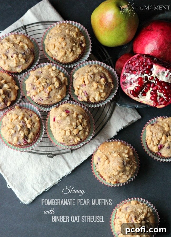 Close-up of fluffy pomegranate pear muffins with golden ginger oat streusel topping