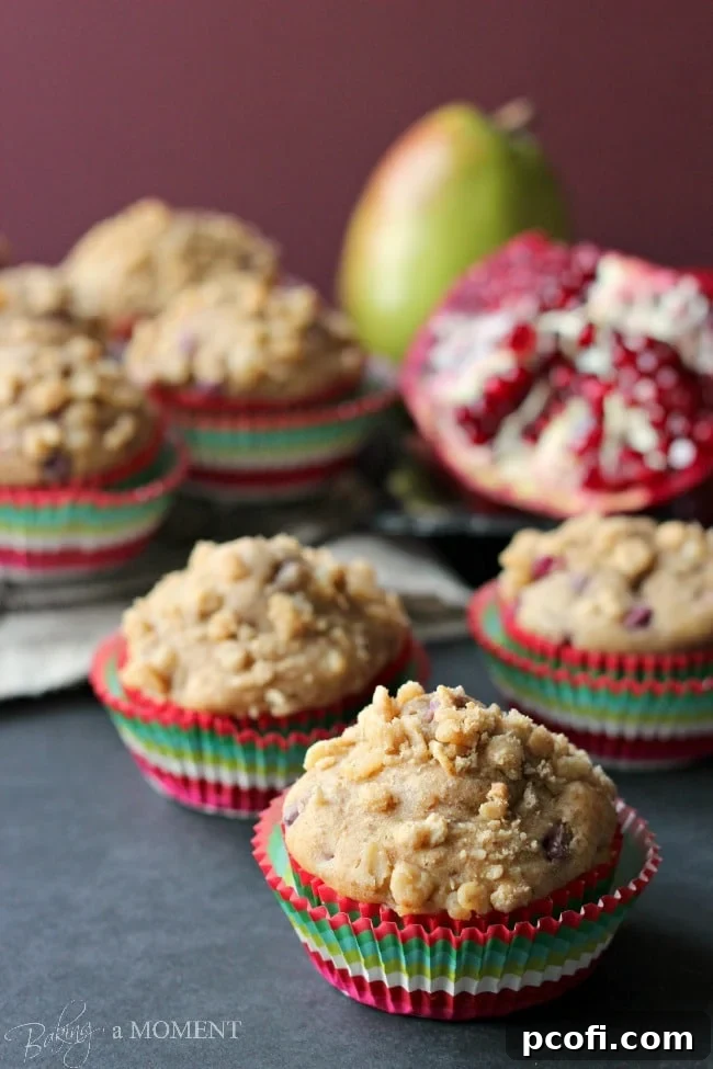 Plate of freshly baked healthy pomegranate pear muffins with ginger oat streusel
