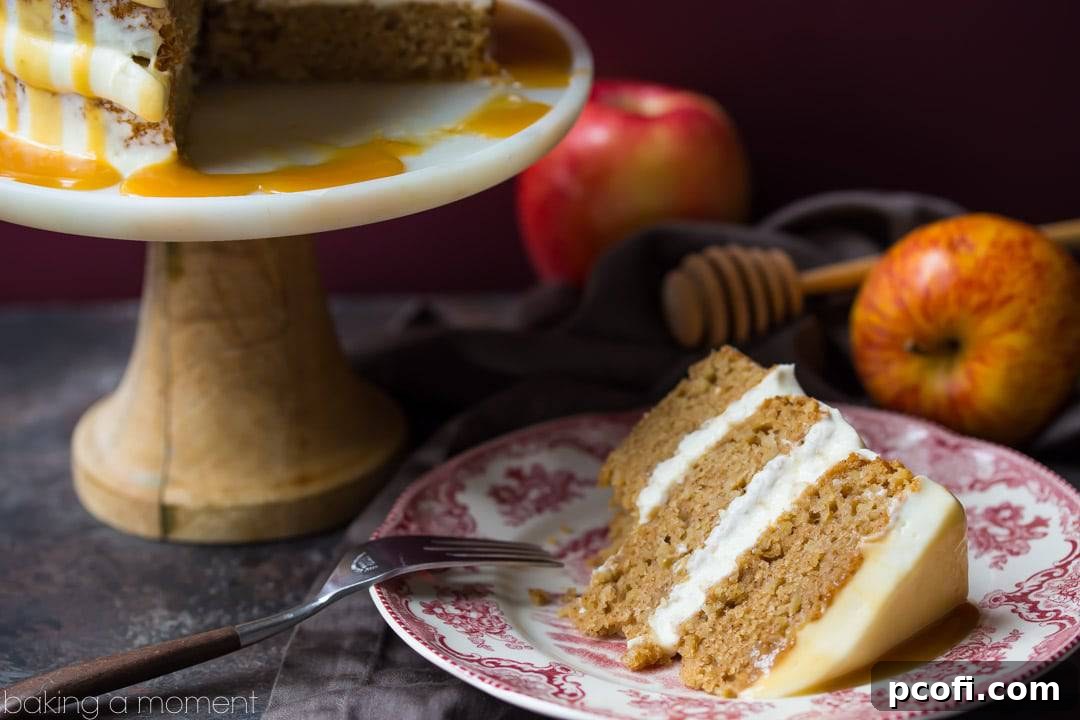 An inviting view of the Apple Honey Cake, with its delicate layers, rich frosting, and a generous pour of honey caramel, ready to be enjoyed.