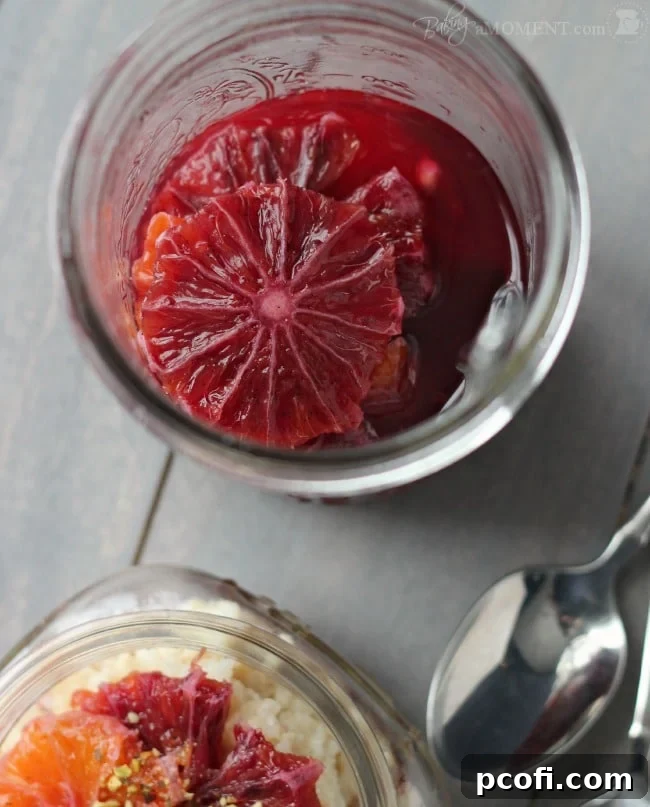 Close-up of vibrant blood orange slices simmering in a rich vanilla cardamom syrup, infusing with exotic flavors.