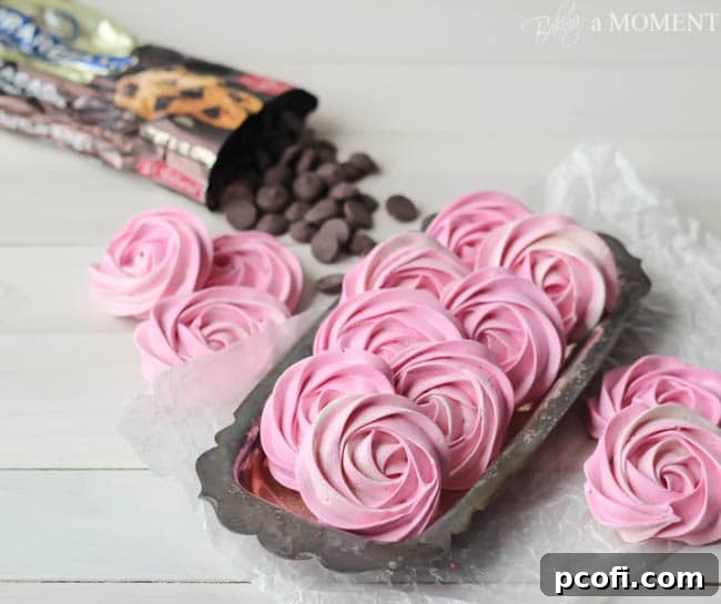 Freshly piped raspberry meringues waiting to be baked to perfection