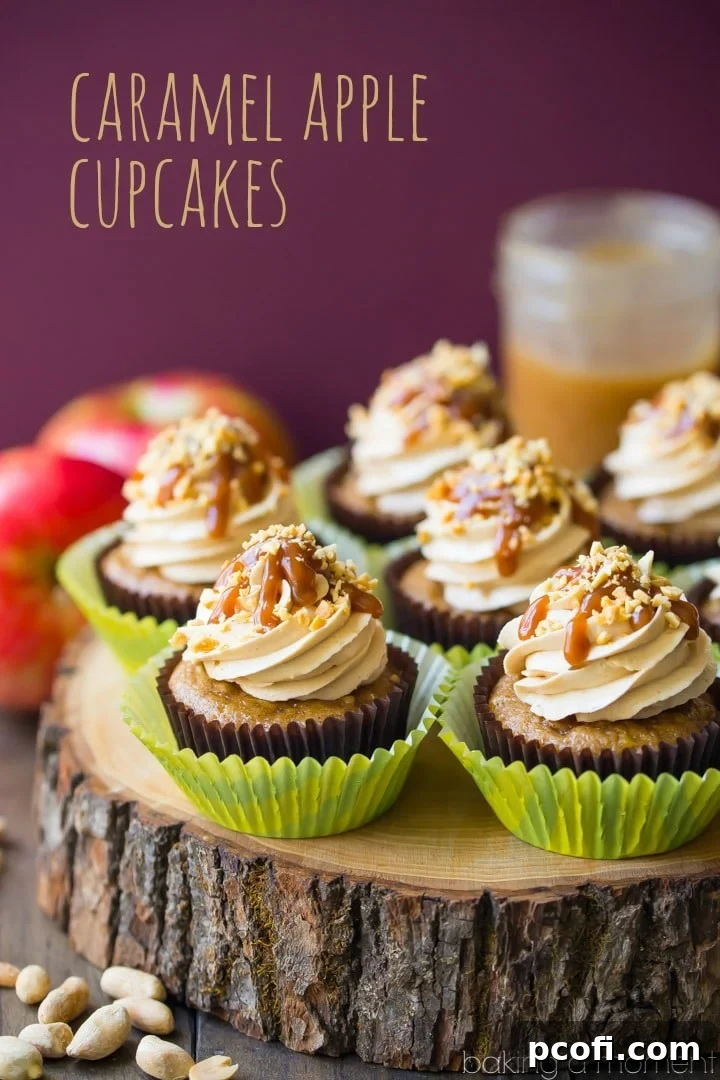 Close-up of caramel apple cupcakes, featuring moist apple cake, salted caramel buttercream, and a generous drizzle of caramel sauce topped with chopped peanuts. This delightful dessert captures the essence of fall's favorite treat. Keywords: food, desserts, apple, caramel, cupcakes.