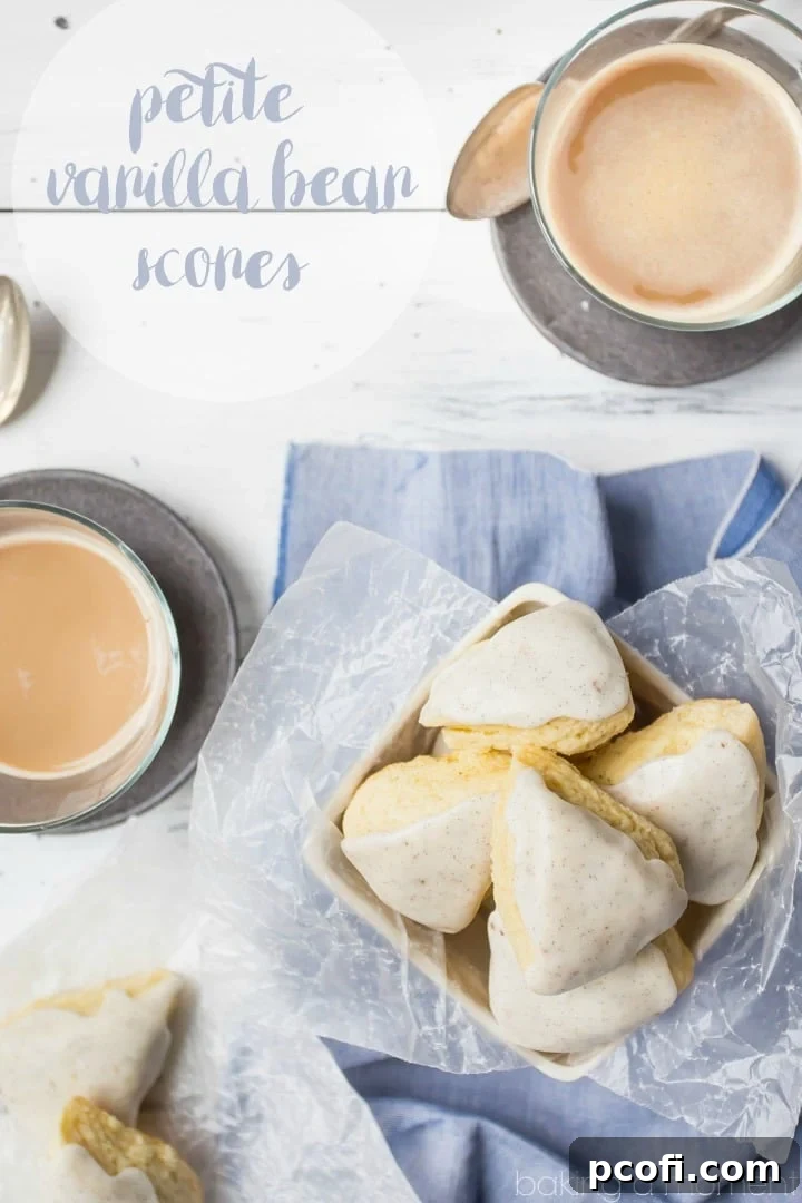 Close-up of golden-brown, glazed vanilla bean scones, showcasing their delicate texture and the visible specks of real vanilla bean in the glaze, ready to be enjoyed with coffee.