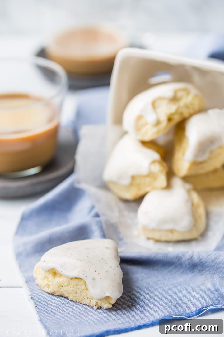 A stack of warm, petite vanilla bean scones, freshly baked and glazed, capturing the enticing aroma of homemade goodness perfect for breakfast or brunch.