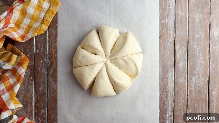 Pretzel dough divided into eight uniform portions on a clean surface, ready for shaping.
