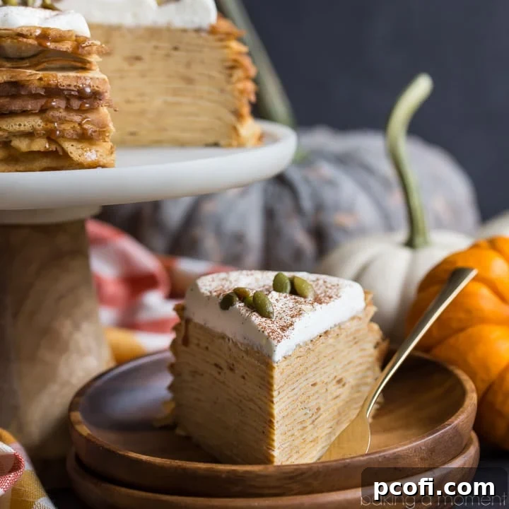 An intricate Pumpkin Crepe Cake: layer upon layer of delicate crepes, filled with a fluffy, cinnamon-spiced pumpkin pastry cream, topped with salted caramel and pepitas.