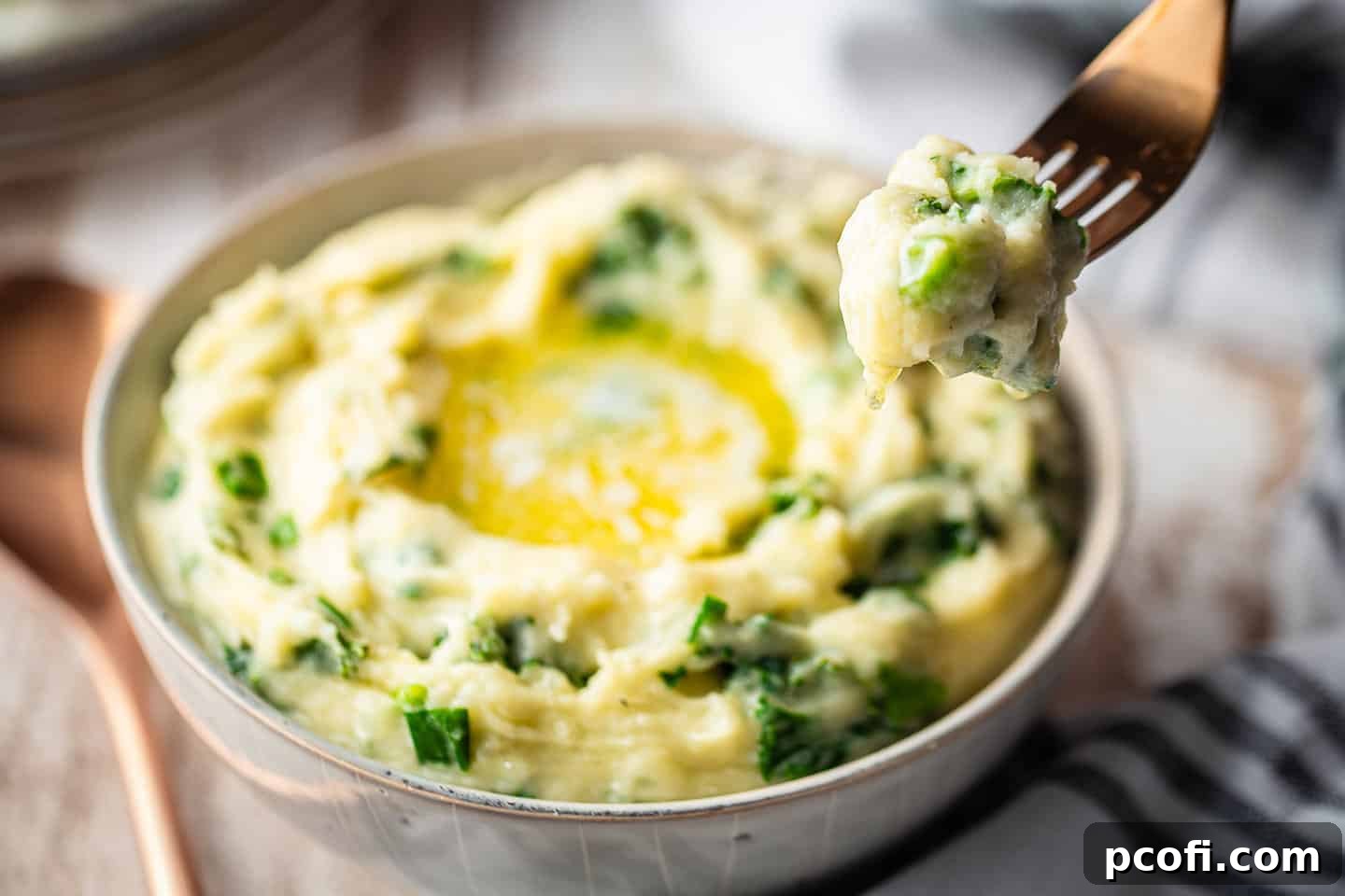 Traditional Irish Colcannon served in an earthenware bowl, with a rustic plaid cloth in the background, exuding comfort and warmth.